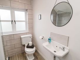 A bathroom with a toilet and wash basin at Canny Cottage in Belford