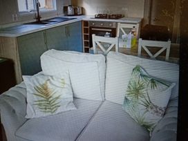 A kitchen with a sofa and cushions at Hedley Wood Park-Duckpool8 Holsworthy