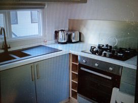 A kitchen with a gas stove and a kettle at Hedley Wood Park-Duckpool8 Holsworthy