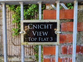 A name plaque for Cnicht View Top Flat 3 at Cnicht View in Porthmadog