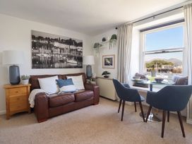 A living room with a sofa and dining table at Cnicht View in Porthmadog