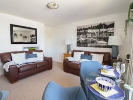 A living room with leather sofas and a mirror at Cnicht View in Porthmadog