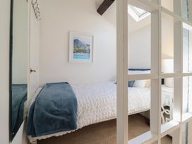 A bedroom with a bed and lamp at Cnicht View Porthmadog