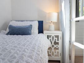 A bedroom with a bed and nightstand at Cnicht View in Porthmadog