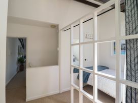 A bedroom with a bed and window at Cnicht View in Porthmadog