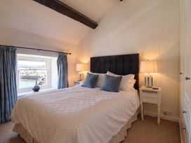 A bedroom with a bed and nightstands at Cnicht View, Porthmadog