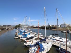 A marina with multiple sailboats at Cnicht View in Porthmadog