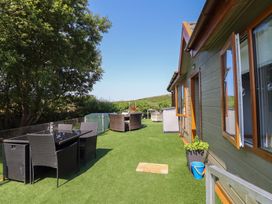 A patio area with outdoor furniture at Excalabur 10 in Morfa Bychan