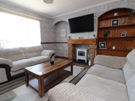 A living room with a coffee table and sofa at 31 Ffordd Y Maer, Pwllheli