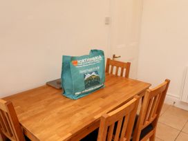 A dining room with a wooden table and chairs at 19 Dunstan View Seahouses