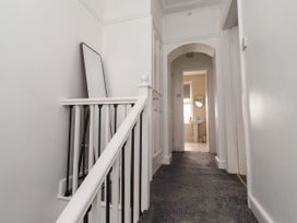 A hallway with a staircase and a bathroom in view at 19 Dunstan View Seahouses