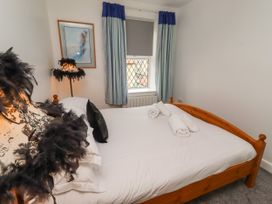 A bedroom with a bed and towels in the room at 19 Dunstan View Seahouses