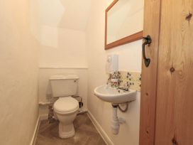 A bathroom with a toilet and sink at Greenwich Cottage in Burton Bradstock