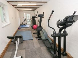 A gym with exercise equipment and mats at Number 19 Ferryside