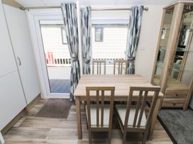 A dining room with a table and chairs at Number 19 in Ferryside