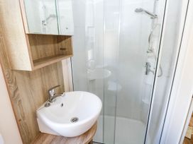A bathroom with a sink and shower at Number 19 Ferryside