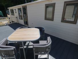 A table and chairs on a deck at Number 19 Ferryside
