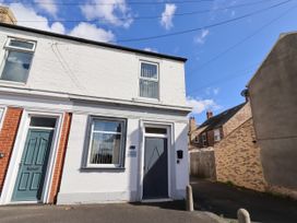 An exterior view of a house on a street at The Old Bank House Red Row near Amble