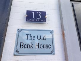 Sign displaying address and name at The Old Bank House in Red Row near Amble