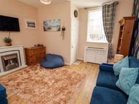 A living room with a sofa and a rug at The Old Bank House Red Row near Amble