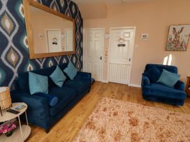 A living room with sofas and a mirror at The Old Bank House Red Row near Amble