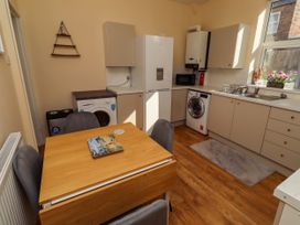 A kitchen with a table and chairs at The Old Bank House Red Row near Amble