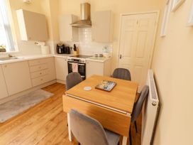 A kitchen with a table and chairs at The Old Bank House Red Row near Amble