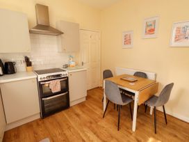 A kitchen with a dining table and chairs at The Old Bank House Red Row near Amble