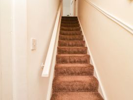 A staircase with carpet and handrail at The Old Bank House Red Row near Amble