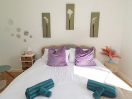A bedroom with a bed and decorations at The Old Bank House Red Row near Amble