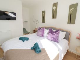 A bedroom with a bed and television at The Old Bank House Red Row near Amble