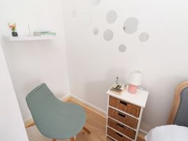 A reading corner with a chair and shelf at The Old Bank House Red Row near Amble
