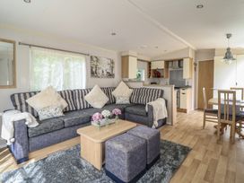 A living room with a sofa and coffee table at Plot 13A
