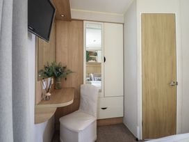 A bedroom with a mirror and desk at Plot 13A in 