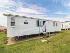 A mobile home with steps and windows at 42 Oak Green
