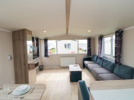 A living room with a sofa and a coffee table at 42 Oak Green