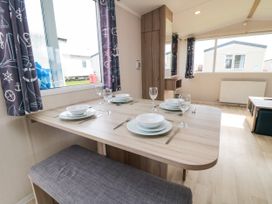 A dining room with a table set for a meal at 42 Oak Green