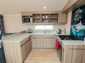 A kitchen with a sink and stove at 42 Oak Green