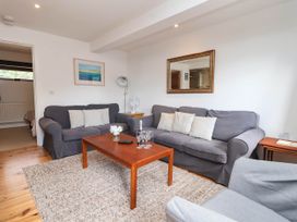 A living room with a sofa and coffee table at Iris at Stancombe Manor, Sherford near Chillington