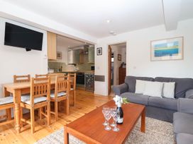 A living room with a dining table and sofa at Iris at Stancombe Manor in Sherford near Chillington