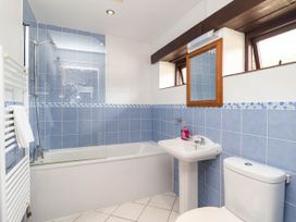 A bathroom with a bathtub, sink, toilet and shower at Iris at Stancombe Manor in Sherford near Chillington