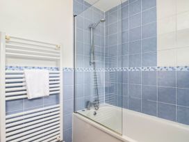 A bathroom with a bathtub and shower at Iris at Stancombe Manor in Sherford near Chillington