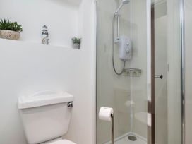 A bathroom with a shower and toilet at Iris at Stancombe Manor, Sherford near Chillington