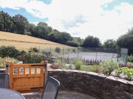 A garden with a tennis court view at Iris at Stancombe Manor Sherford near Chillington