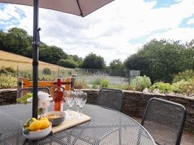 A table with drinks and snacks in a garden at Iris at Stancombe Manor Sherford near Chillington