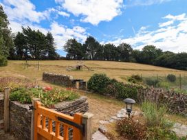 An outdoor area with a swing set and pathway at Iris at Stancombe Manor Sherford near Chillington