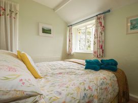 A bedroom with a bed and window at The Granary