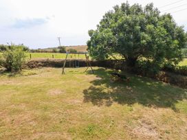 An outdoor area with a swing set and a tree at The Granary