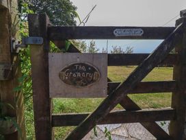 A wooden gate with a sign at The Granary 