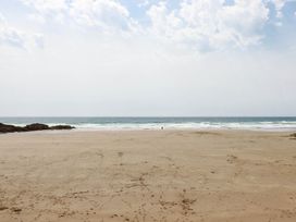 A beach scene with sand and ocean waves at The Granary in 